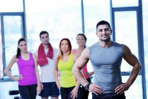 Group of people exercising at the gym photo