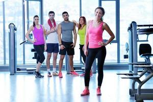 Group of people exercising at the gym photo