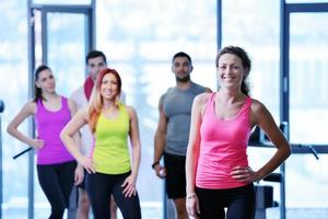 Group of people exercising at the gym photo