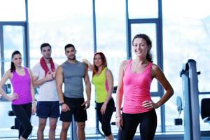 Group of people exercising at the gym photo