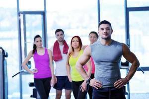 Group of people exercising at the gym photo