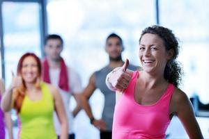 Group of people exercising at the gym photo