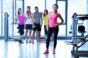 Group of people exercising at the gym photo