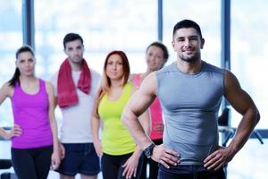 Group of people exercising at the gym photo