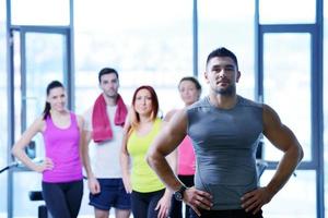 Group of people exercising at the gym photo