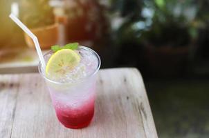 Summer tasty drink, fresh lemon iced with soda and berry in the cafe, summer concept photo