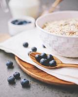 Close up of organic fresh blueberry and cereal with milk for healthy breakfast, ready to eat concept photo