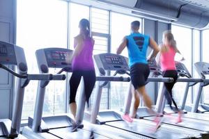 Group of people running on treadmills photo