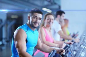 Group of people running on treadmills photo