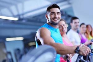 Group of people running on treadmills photo