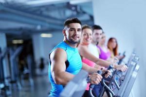 Group of people running on treadmills photo