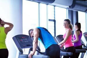 Group of people running on treadmills photo