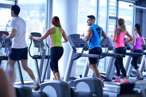 Group of people running on treadmills photo