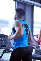 man running on the treadmill photo