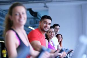 Group of people running on treadmills photo
