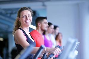 Group of people running on treadmills photo