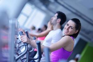 Group of people running on treadmills photo