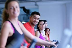 Group of people running on treadmills photo