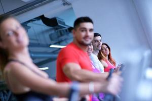 Group of people running on treadmills photo