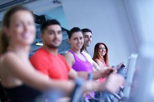 Group of people running on treadmills photo