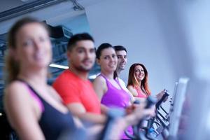 Group of people running on treadmills photo