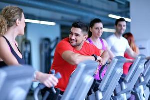 Group of people running on treadmills photo