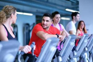 Group of people running on treadmills photo