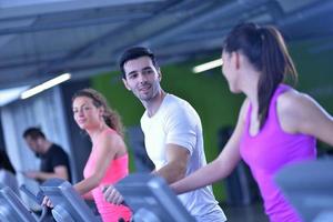 Group of people running on treadmills photo