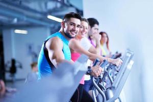 Group of people running on treadmills photo