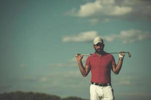 handsome middle eastern golf player portrait at course photo