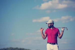 handsome middle eastern golf player portrait at course photo