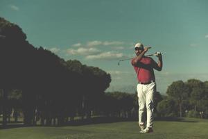 golf player hitting long shot photo