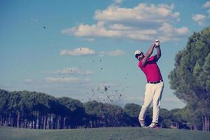 golf player hitting long shot photo