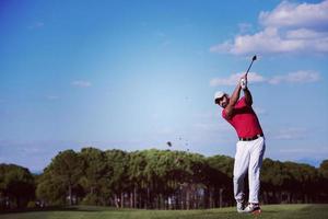 golf player hitting long shot photo