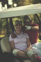 couple in buggy on golf course photo