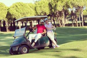 couple in buggy on golf course photo