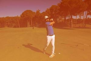 golf player hitting shot photo