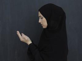 Portrait of young Muslim woman making dua photo