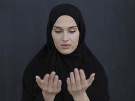 Portrait of young Muslim woman making dua photo