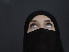 Portrait of muslim woman wearing niqab and traditional arabic clothes or abaya photo