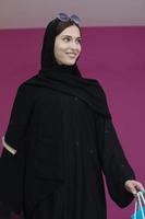 Happy muslim girl posing with shopping bags photo