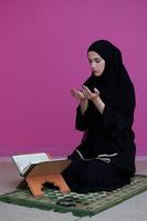 Middle eastern woman praying and reading the holy Quran Sarajevo photo