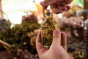 potion bottle in hand of herbalist photo