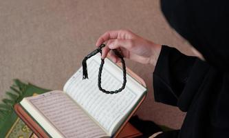 Middle eastern woman praying and reading the holy Quran Sarajevo photo