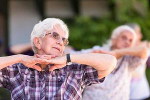 senior woman exercising with friends photo