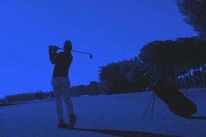 golf player hitting shot photo