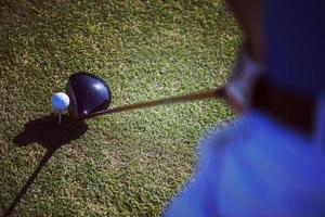 top view of golf club and ball in grass photo