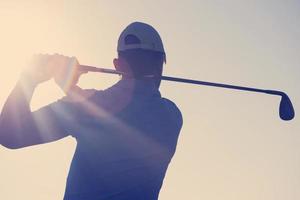 golf player hitting shot photo