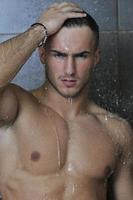 good looking man under man shower photo