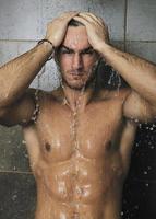 good looking man under man shower photo